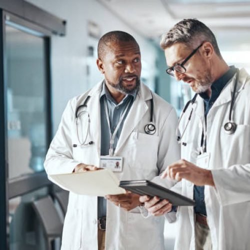 Hospital, teamwork and doctors with folder, tablet and brainstorming for healthcare and administration. Medical, leader and senior professional with tech and meeting with documents and share info